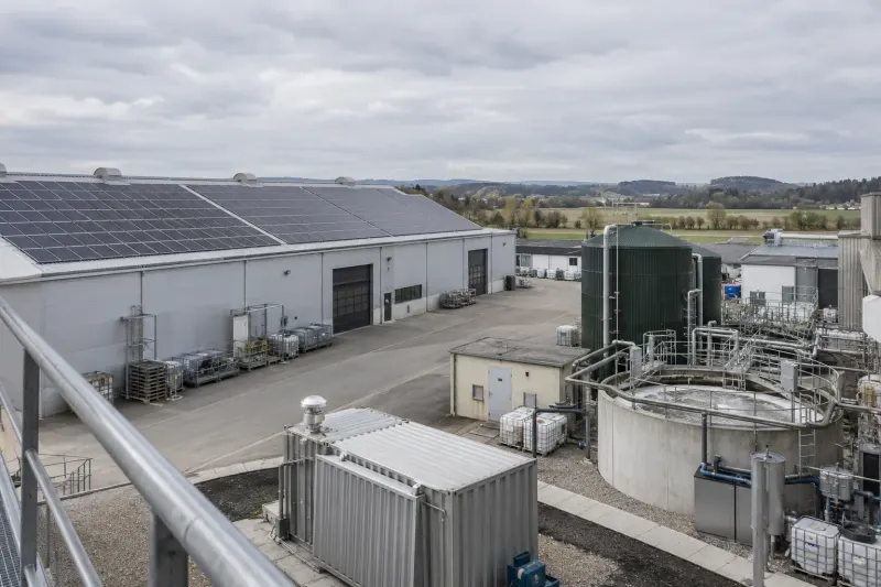 Industrial site with rooftop solar panels and water-treatment equipment